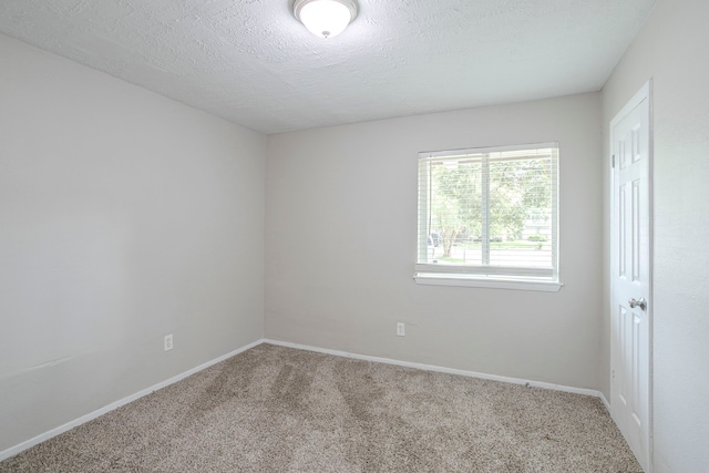 5102 Enchanted Timbers Dr, Humble, TX 77346 - empty room featuring carpet floors, baseboards, and a textured ceiling