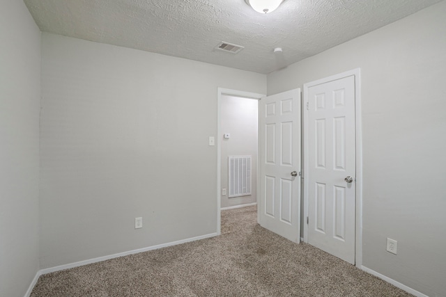 5102 Enchanted Timbers Dr, Humble, TX 77346 - unfurnished bedroom with carpet, baseboards, and a textured ceiling