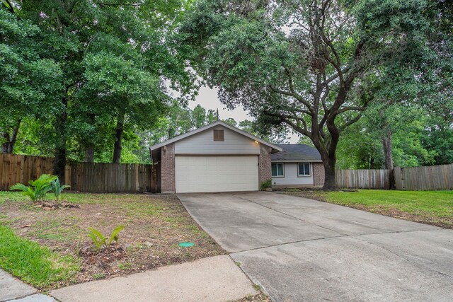 5102 Enchanted Timbers Dr, Humble, TX 77346 - ranch-style home featuring brick siding, driveway, and a garage