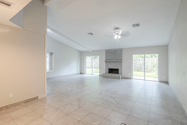 5102 Enchanted Timbers Dr, Humble, TX 77346 - unfurnished living room with ceiling fan, light tile patterned floors, vaulted ceiling, a brick fireplace, and baseboards