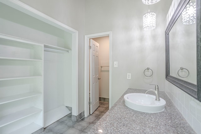 5102 Enchanted Timbers Dr, Humble, TX 77346 - bathroom with a sink, a spacious closet, and baseboards