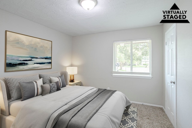 5102 Enchanted Timbers Dr, Humble, TX 77346 - bedroom with carpet flooring, baseboards, and a textured ceiling
