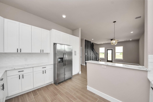 11141 Rd 5503, Cleveland, TX 77327 - kitchen with stainless steel refrigerator with ice dispenser, white cabinetry, light stone counters, and recessed lighting