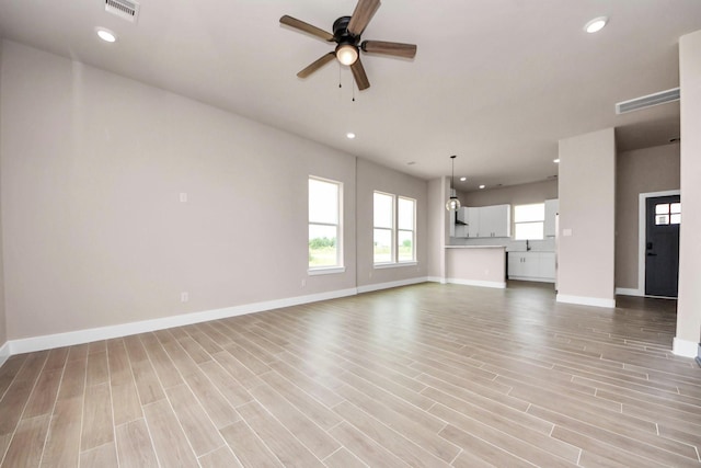 11141 Rd 5503, Cleveland, TX 77327 - unfurnished living room with a ceiling fan, baseboards, recessed lighting, and light wood-style flooring