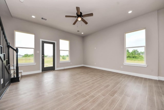 11141 Rd 5503, Cleveland, TX 77327 - unfurnished living room featuring light wood finished floors, baseboards, healthy amount of natural light, and recessed lighting