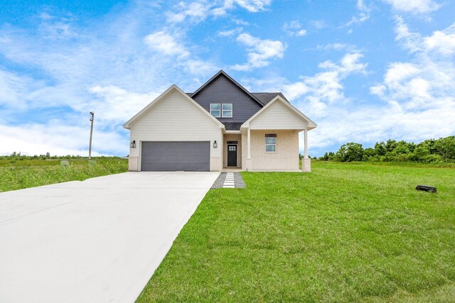 11141 Rd 5503, Cleveland, TX 77327 - view of front facade featuring concrete driveway, a front yard, an attached garage, and brick siding