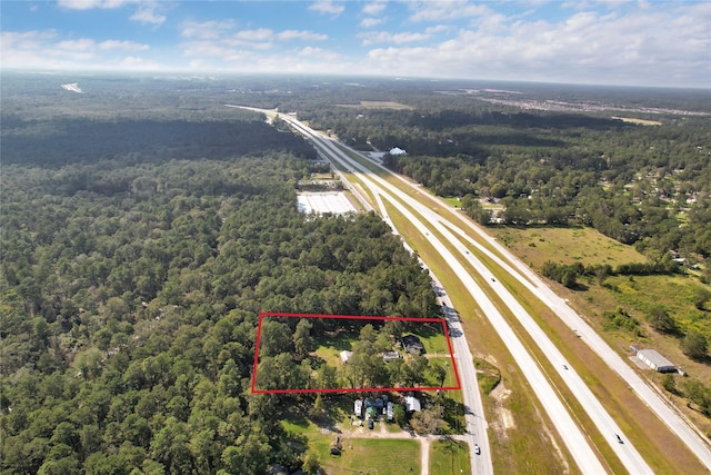 26472 Fm 1485th Rd, New Caney, TX 77357 - aerial overview of property's location featuring a heavily wooded area, property boundaries highlighted, and a main thoroughfare