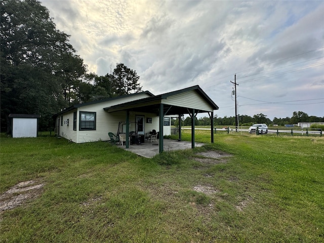 26472 Fm 1485th Rd, New Caney, TX 77357 - back of property with a patio, a yard, a shed, and an outdoor structure