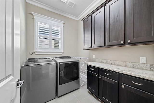 436 W 26th St, Houston, TX 77008 - laundry room featuring crown molding, washing machine and clothes dryer, cabinet space, and light tile patterned floors