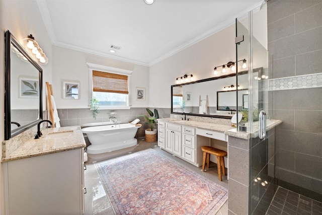 436 W 26th St, Houston, TX 77008 - full bath featuring a stall shower, tile walls, crown molding, two vanities, and a freestanding bath
