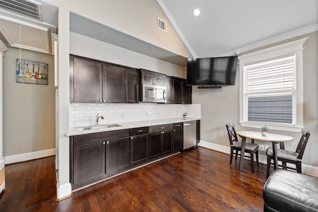 436 W 26th St, Houston, TX 77008 - kitchen featuring lofted ceiling, stainless steel appliances, decorative backsplash, ornamental molding, and a sink