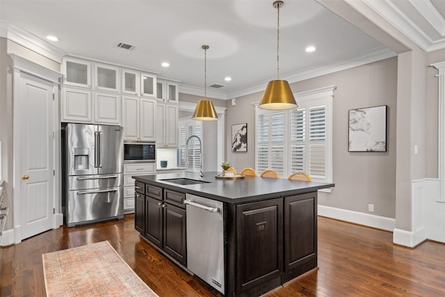 436 W 26th St, Houston, TX 77008 - kitchen featuring appliances with stainless steel finishes, a sink, white cabinets, dark countertops, and ornamental molding