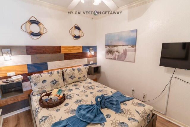 6300 Seawall Blvd Unit 9228, Galveston, TX 77551 - bedroom featuring crown molding, wood finished floors, and a ceiling fan