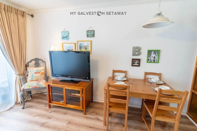 6300 Seawall Blvd Unit 9228, Galveston, TX 77551 - dining space featuring light wood-style flooring and ornamental molding