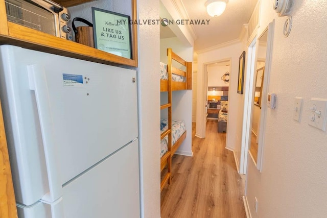 6300 Seawall Blvd Unit 9228, Galveston, TX 77551 - hall featuring light wood-style floors and ornamental molding