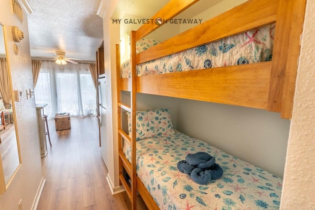 6300 Seawall Blvd Unit 9228, Galveston, TX 77551 - bedroom featuring wood finished floors and a textured ceiling