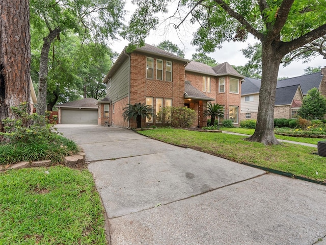 traditional-style house with brick siding, a garage, a front lawn, and an outdoor structure
