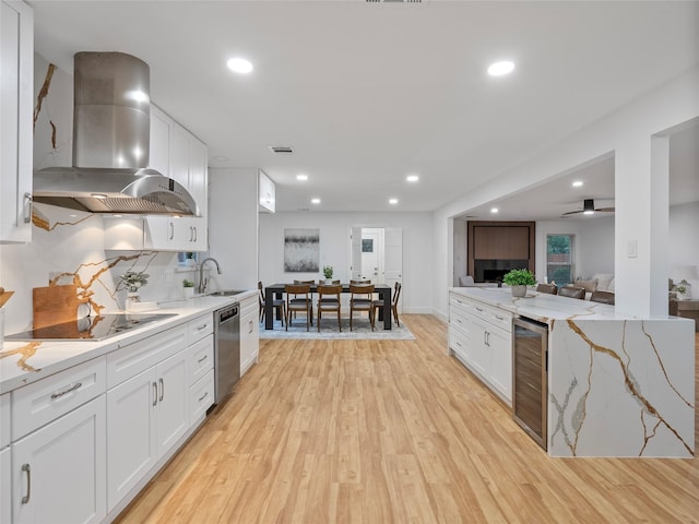 kitchen featuring ventilation hood, dishwasher, black electric stovetop, wine cooler, and white cabinetry