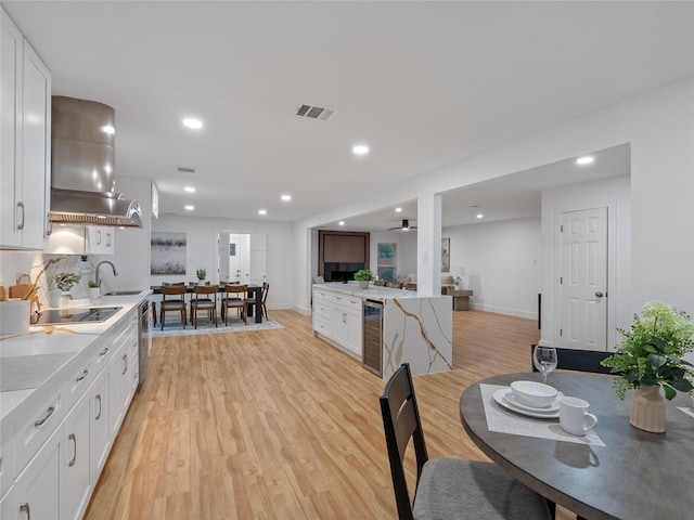 dining room with beverage cooler, light wood-style flooring, baseboards, recessed lighting, and ceiling fan