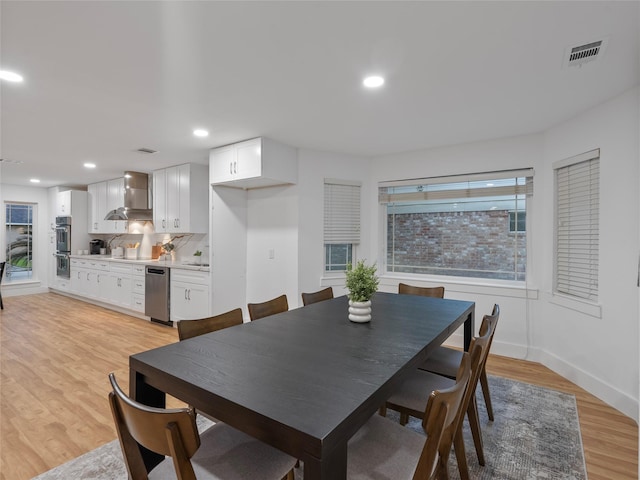 dining space featuring light wood-style flooring, baseboards, and recessed lighting