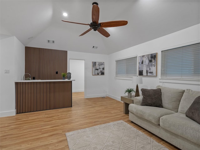 living room with a ceiling fan, baseboards, light wood-style floors, and high vaulted ceiling