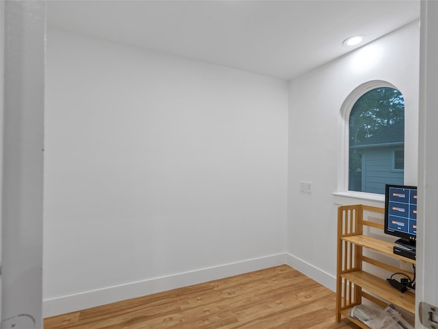 empty room featuring light wood-type flooring, baseboards, and recessed lighting