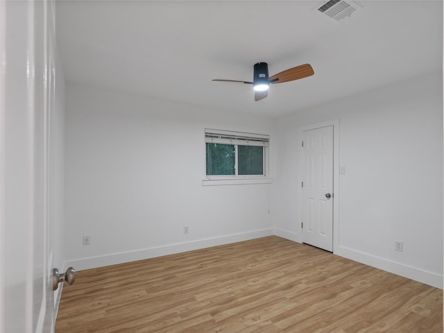 unfurnished room with a ceiling fan, light wood finished floors, and baseboards