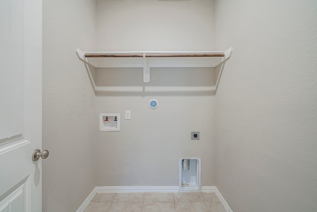 16702 Peralta Bay Cir, Crosby, TX 77532 - clothes washing area with hookup for an electric dryer, hookup for a gas dryer, washer hookup, baseboards, and light tile patterned floors