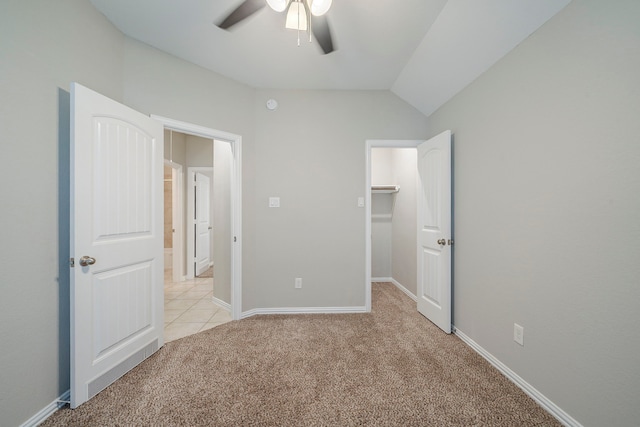 16702 Peralta Bay Cir, Crosby, TX 77532 - unfurnished bedroom with light carpet, a walk in closet, a ceiling fan, vaulted ceiling, and baseboards