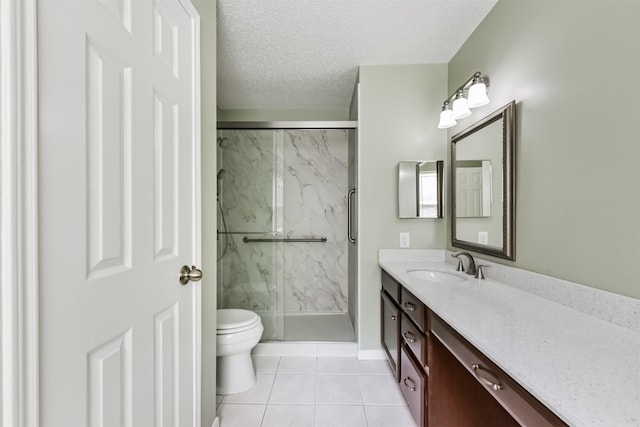bathroom featuring toilet, a marble finish shower, vanity, a textured ceiling, and tile patterned flooring
