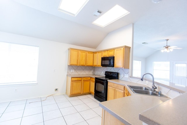 kitchen with black appliances, a sink, vaulted ceiling, backsplash, and light brown cabinets