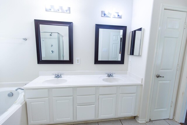 full bath featuring a garden tub, double vanity, tile patterned flooring, and a shower