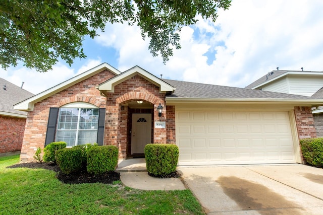 view of front of house with brick siding, driveway, an attached garage, and roof with shingles