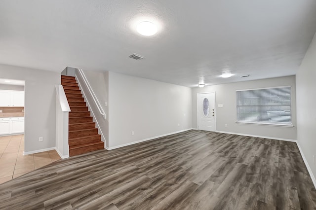 14418 Cellini Dr, Cypress, TX 77429 - unfurnished living room featuring stairway, wood finished floors, and baseboards