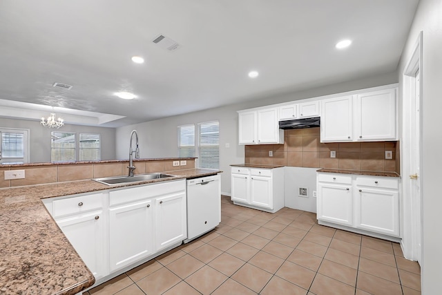 14418 Cellini Dr, Cypress, TX 77429 - kitchen featuring white dishwasher, a sink, a chandelier, under cabinet range hood, and decorative backsplash
