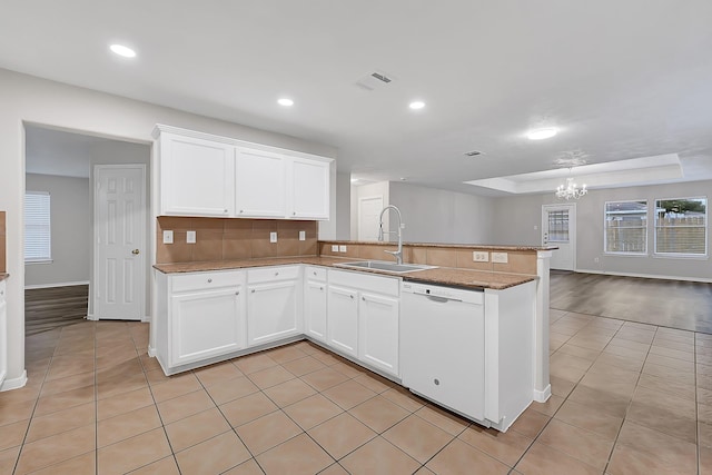 14418 Cellini Dr, Cypress, TX 77429 - kitchen with a sink, white dishwasher, a chandelier, a peninsula, and light tile patterned floors