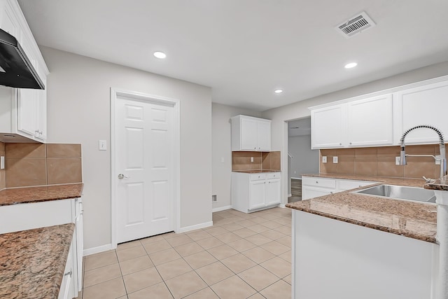 14418 Cellini Dr, Cypress, TX 77429 - kitchen featuring a sink, tasteful backsplash, white cabinetry, recessed lighting, and wall chimney exhaust hood