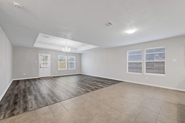 14418 Cellini Dr, Cypress, TX 77429 - spare room with a chandelier, baseboards, wood finished floors, a tray ceiling, and a smoke detector