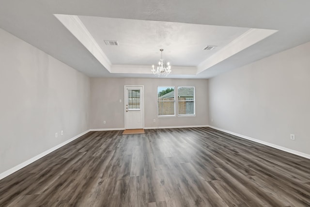 14418 Cellini Dr, Cypress, TX 77429 - spare room with a tray ceiling, a chandelier, dark wood finished floors, baseboards, and crown molding