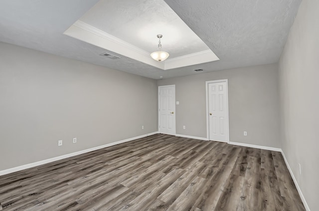 14418 Cellini Dr, Cypress, TX 77429 - empty room with a raised ceiling, dark wood-type flooring, baseboards, crown molding, and a textured ceiling