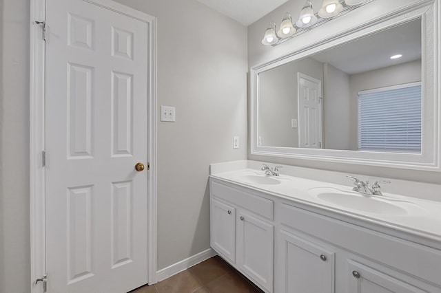14418 Cellini Dr, Cypress, TX 77429 - bathroom featuring tile patterned floors, double vanity, and baseboards