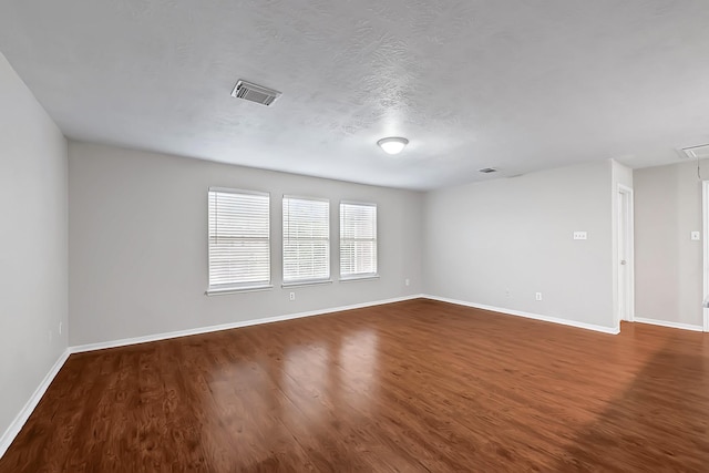14418 Cellini Dr, Cypress, TX 77429 - spare room with baseboards, dark wood-style flooring, and attic access