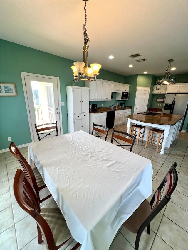 dining room with a chandelier, light tile patterned flooring, recessed lighting, and baseboards
