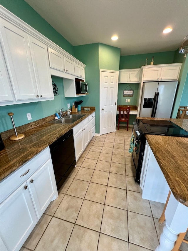 kitchen with black appliances, a sink, white cabinets, light tile patterned flooring, and recessed lighting