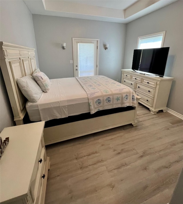 bedroom featuring wood finished floors and baseboards