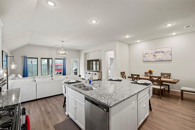 3306 Old Ironwood Dr, Spring, TX 77386 - kitchen with stainless steel dishwasher, a sink, open floor plan, white cabinetry, and light wood-style flooring