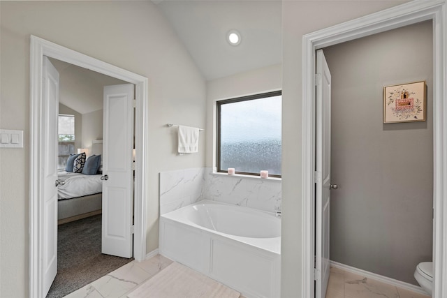 3306 Old Ironwood Dr, Spring, TX 77386 - ensuite bathroom with marble look tile flooring, lofted ceiling, a bath, baseboards, and toilet