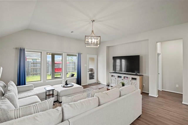 3306 Old Ironwood Dr, Spring, TX 77386 - living room with a chandelier, wood finished floors, baseboards, and lofted ceiling
