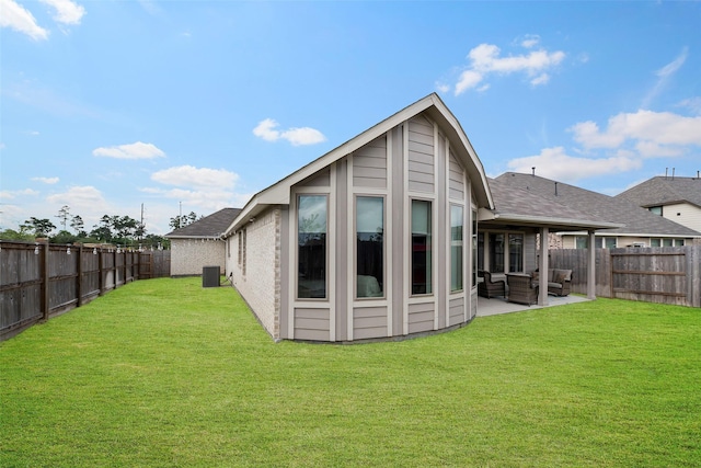 3306 Old Ironwood Dr, Spring, TX 77386 - back of house with an outdoor living space, central AC, a patio area, roof with shingles, and brick siding