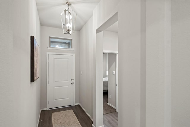 3306 Old Ironwood Dr, Spring, TX 77386 - entryway with a chandelier, dark wood-style floors, and baseboards